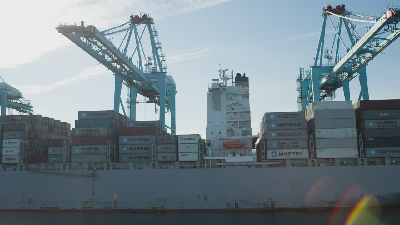 Container ship and cranes at an international cargo port